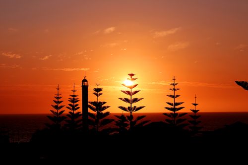 Free A stunning view of Bunbury lighthouse silhouetted against a vibrant sunset in Western Australia. Stock Photo