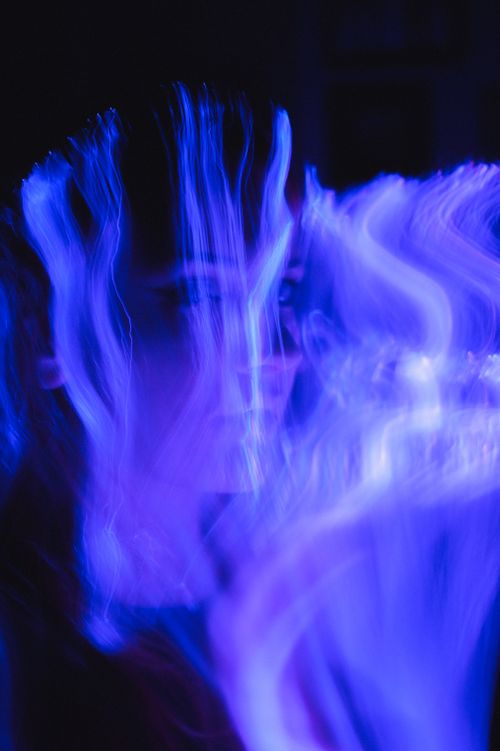 Free Abstract portrait with ethereal blue light trails creating a mysterious atmosphere. Stock Photo
