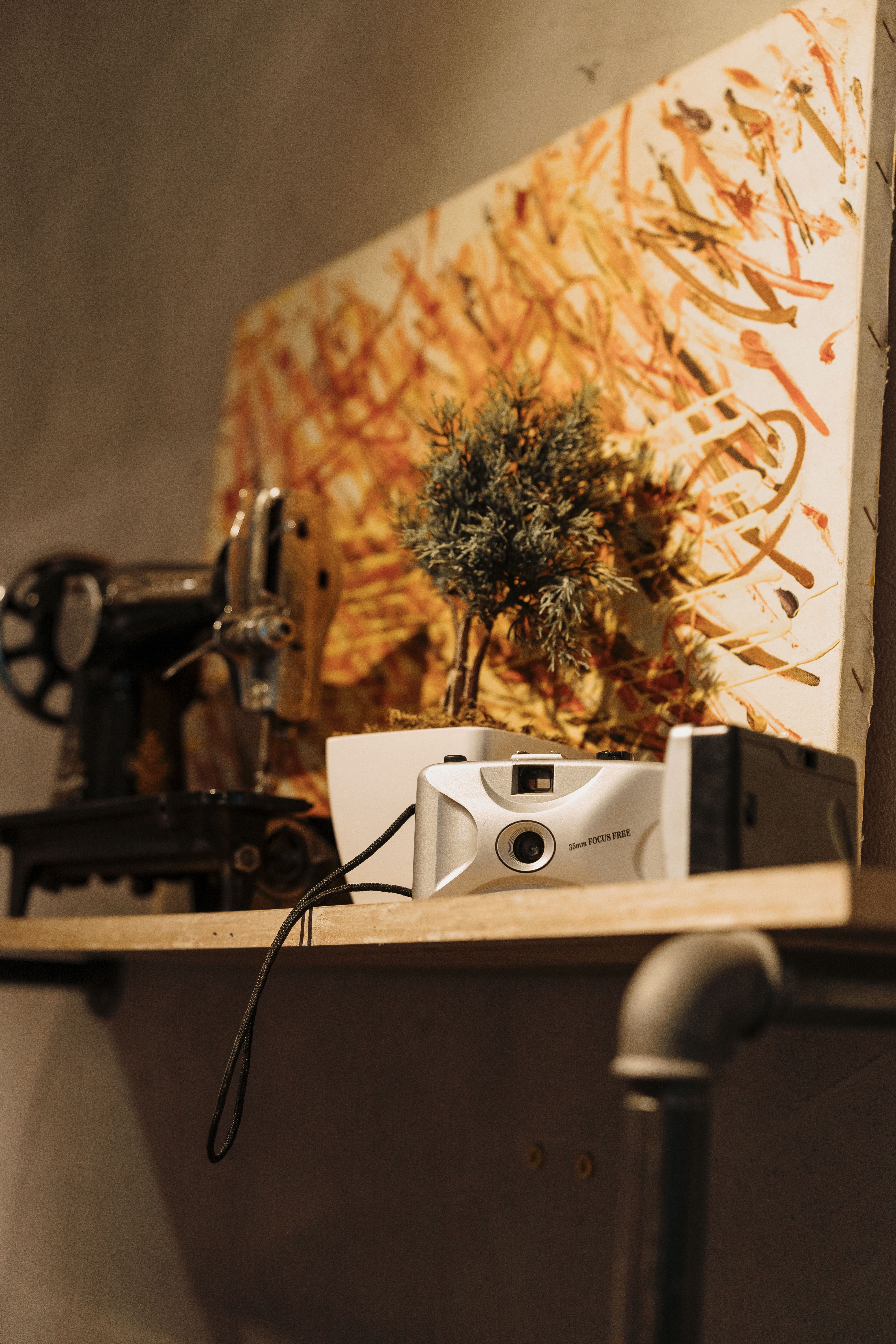 Vintage Sewing Machine with Camera and Art Display · Free Stock Photo