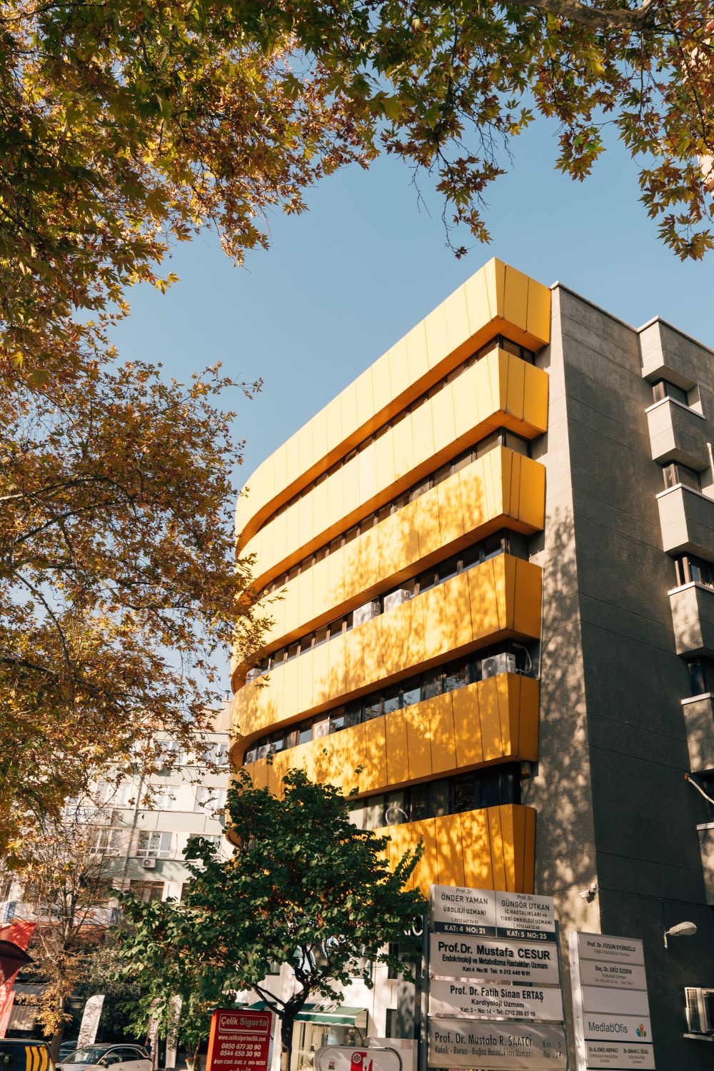 Modern Yellow Building with Autumn Leaves · Free Stock Photo