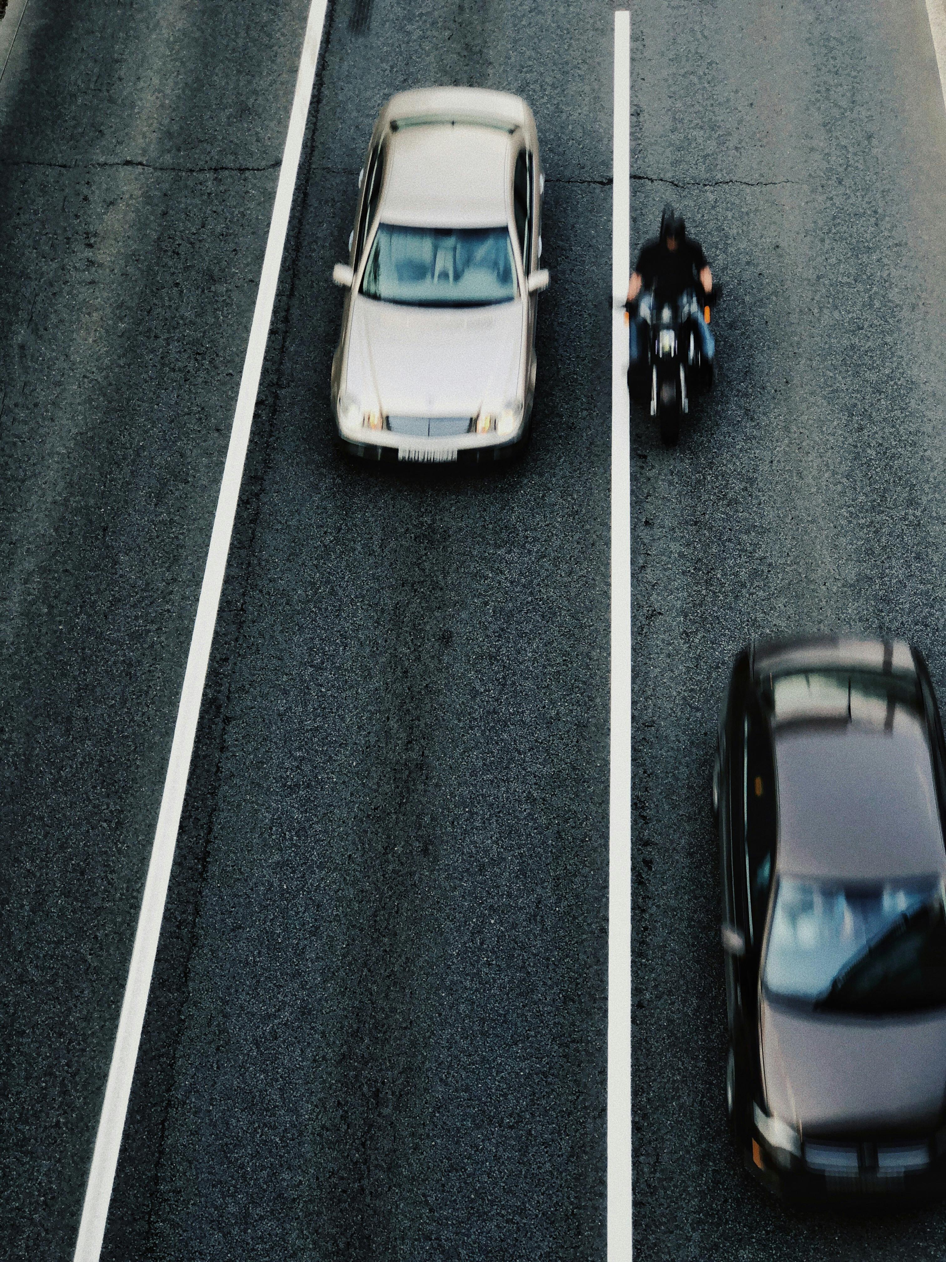 panning photo of cars and motorcycle