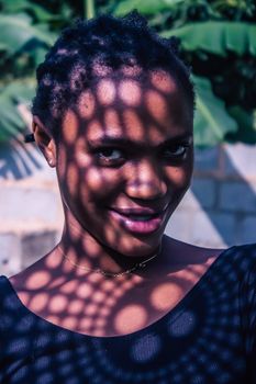 Portrait of a woman with captivating light patterns creating an artistic effect.