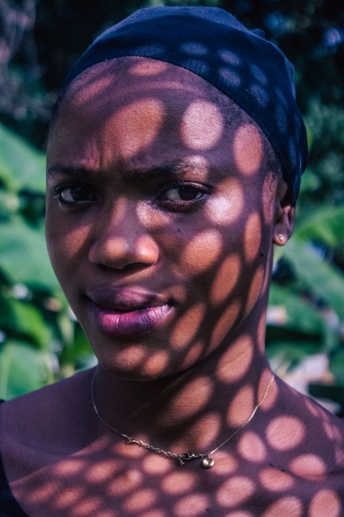 Free A portrait featuring dramatic light pattern shadows cast on the face of an adult woman. Stock Photo