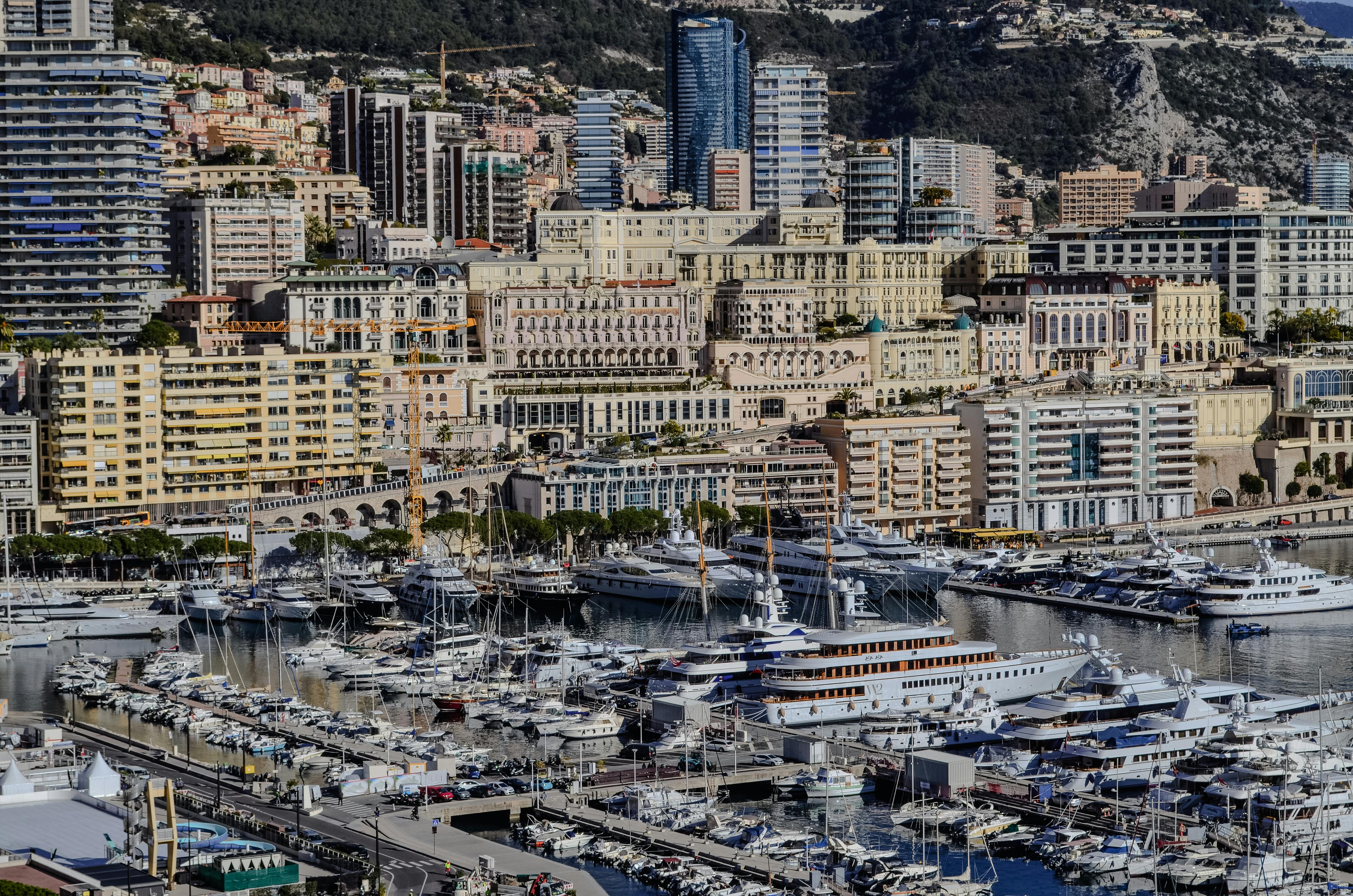 A vibrant view of Monaco's yacht harbor showcasing luxury yachts and urban skyline.