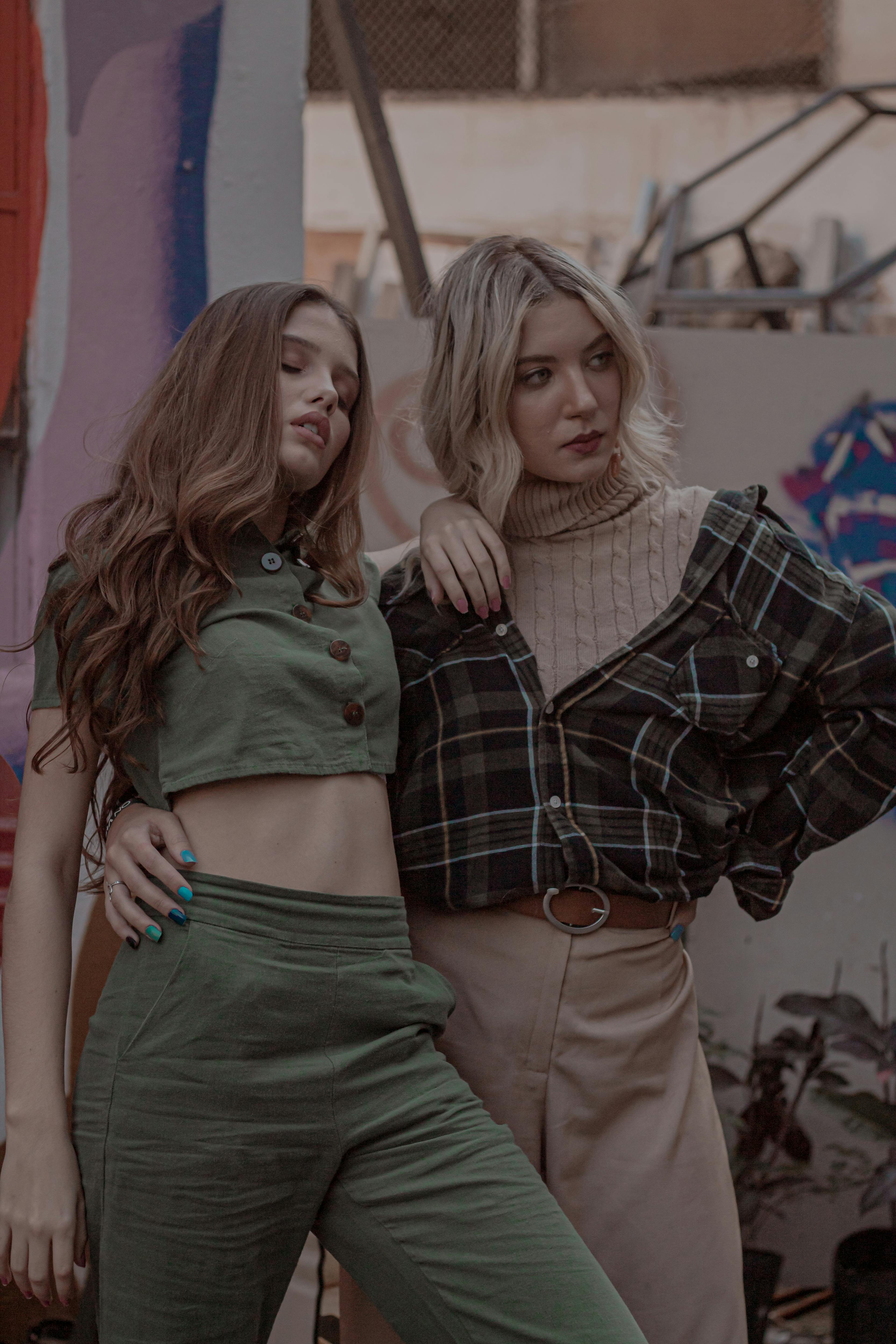 two women standing near wall