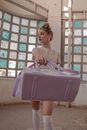 Woman Holding Purple Duffel Bag