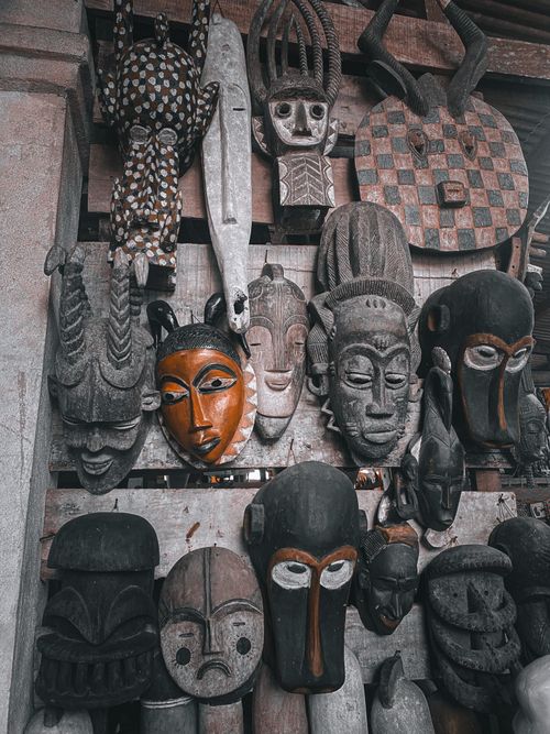 Free Colorful African tribal masks on display in Abidjan market, showcasing rich cultural heritage. Stock Photo