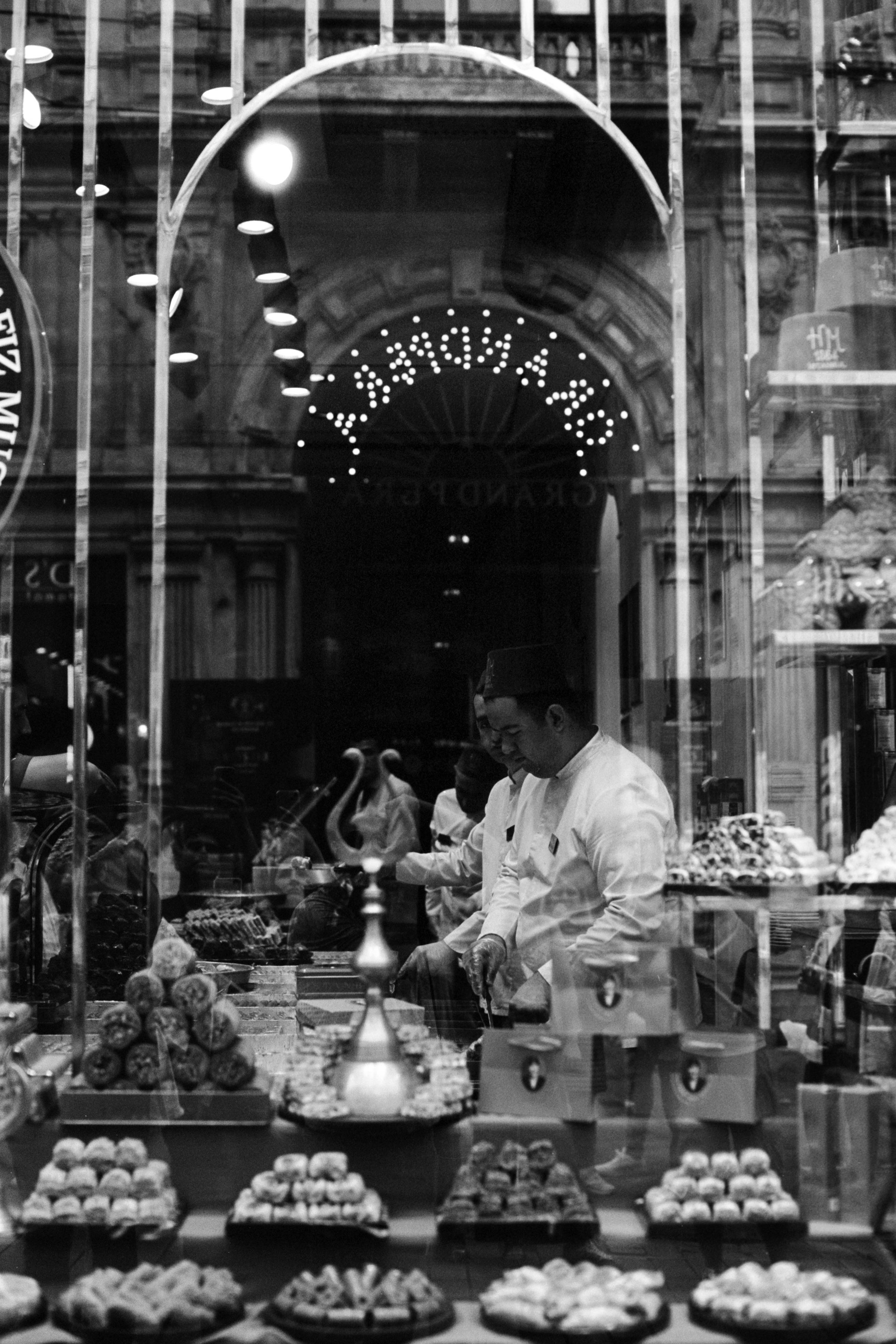 Black and white photo of a traditional sweet shop in Istanbul showcasing local delicacies.
