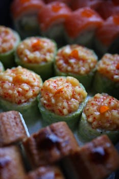 Delicious sushi rolls topped with seafood, showcasing vibrant colors and textures.