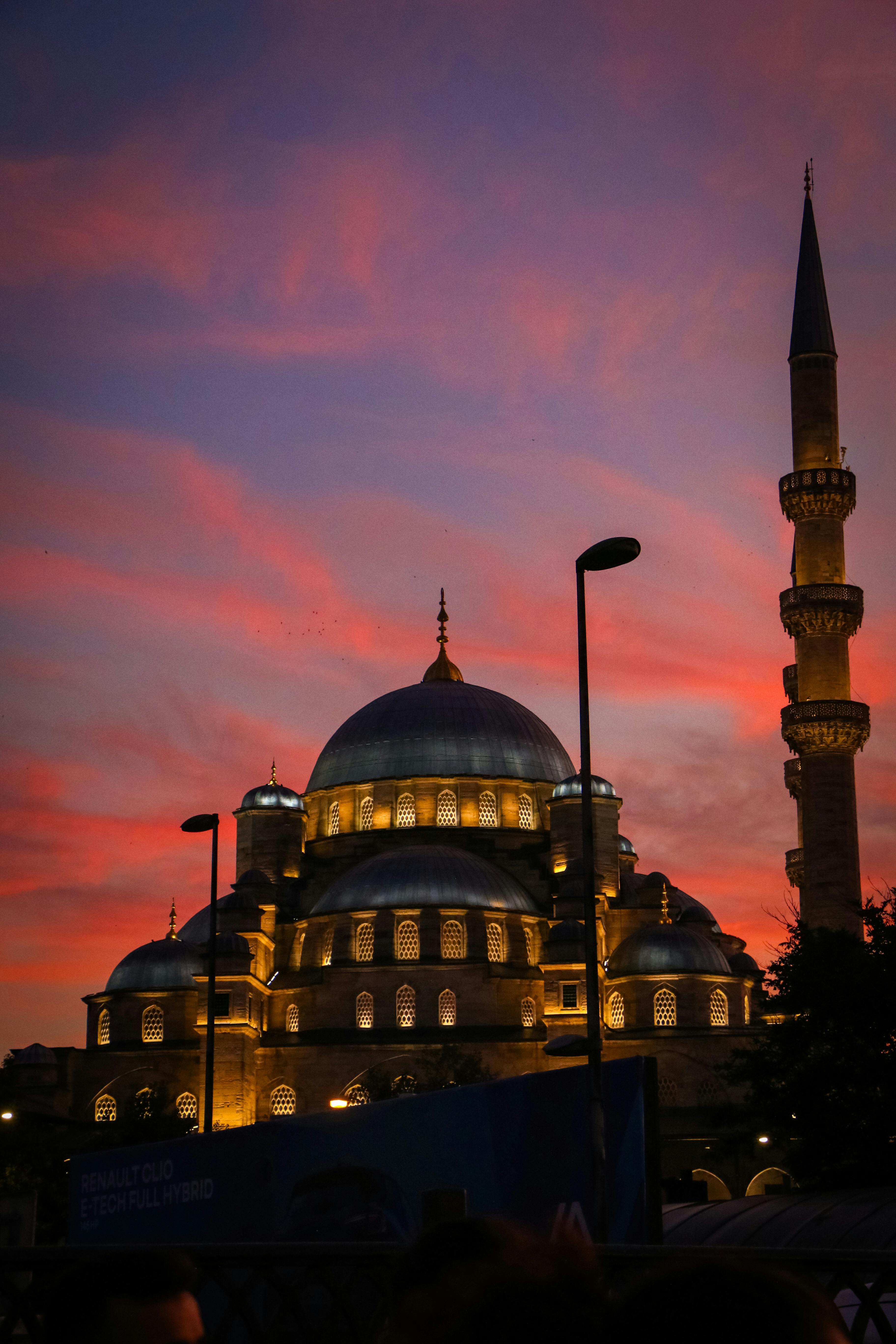 The Blue Mosque in Istanbul silhouetted against a vibrant sunset sky, showcasing its iconic architecture.