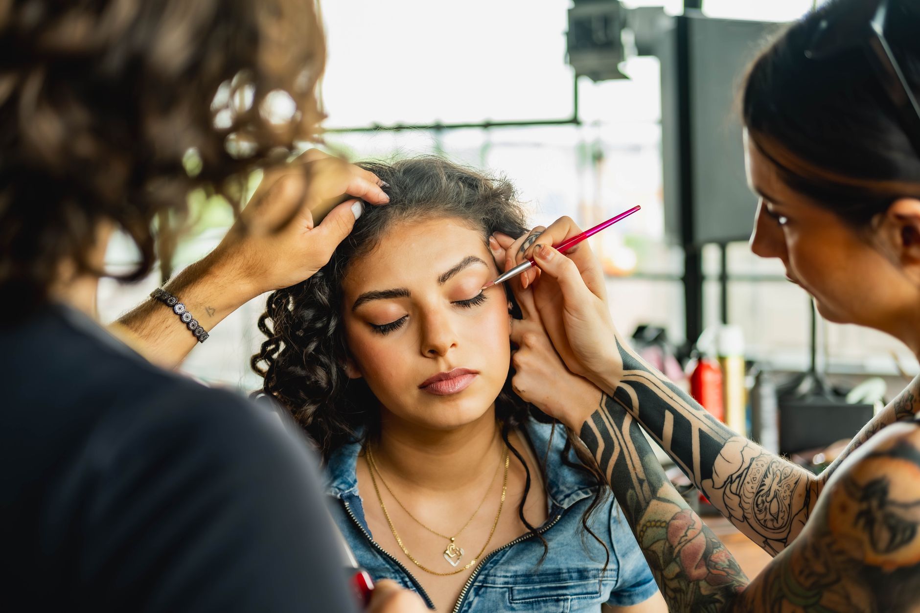 Talented makeup artist applying eyeshadow in a vibrant Toronto studio setting.