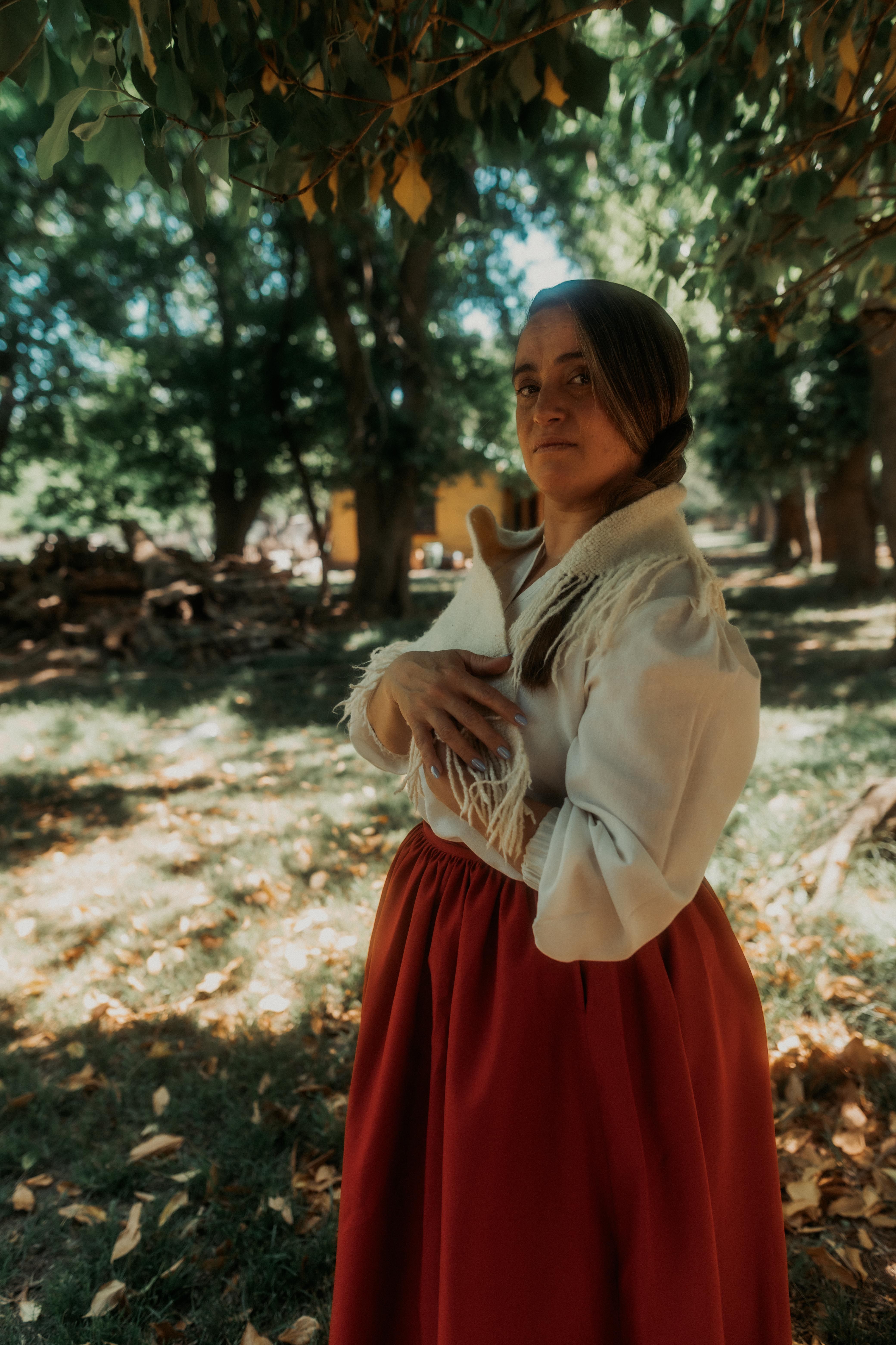 Traditional Woman Posing in Rural Setting · Free Stock Photo