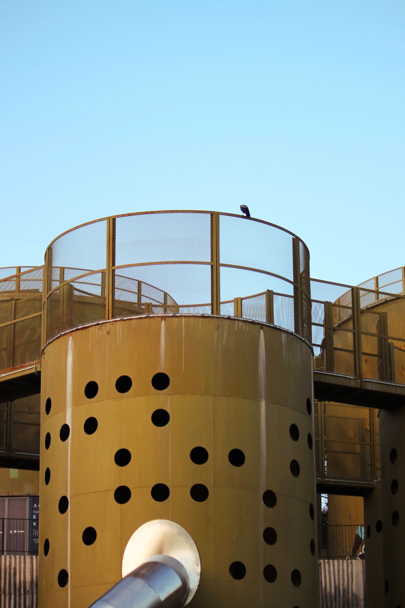 Industrial silos against a clear sky