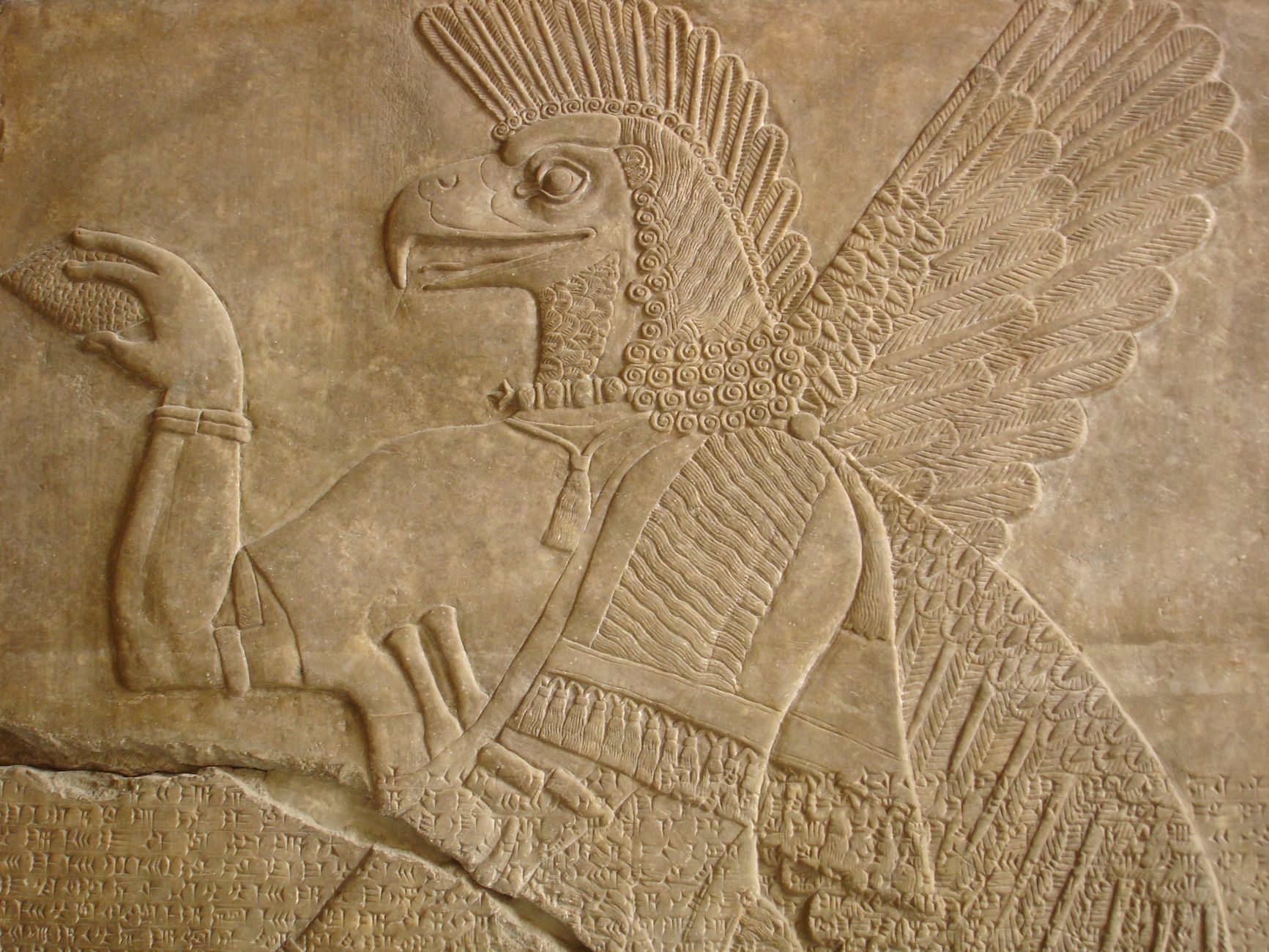 Intricate stone relief depicting a mythological figure from ancient Mesopotamia, showcasing detailed carvings.