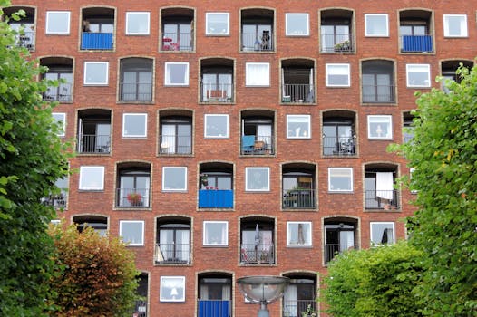 Symmetrical windows of a red brick apartment building in Copenhagen, Denmark.