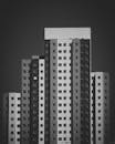 一张引人注目的黑白照片，展现了一座现代高层公寓楼的外观