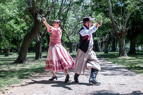 Free Argentine gauchos performing traditional dance in a rural Chascomús setting. Stock Photo