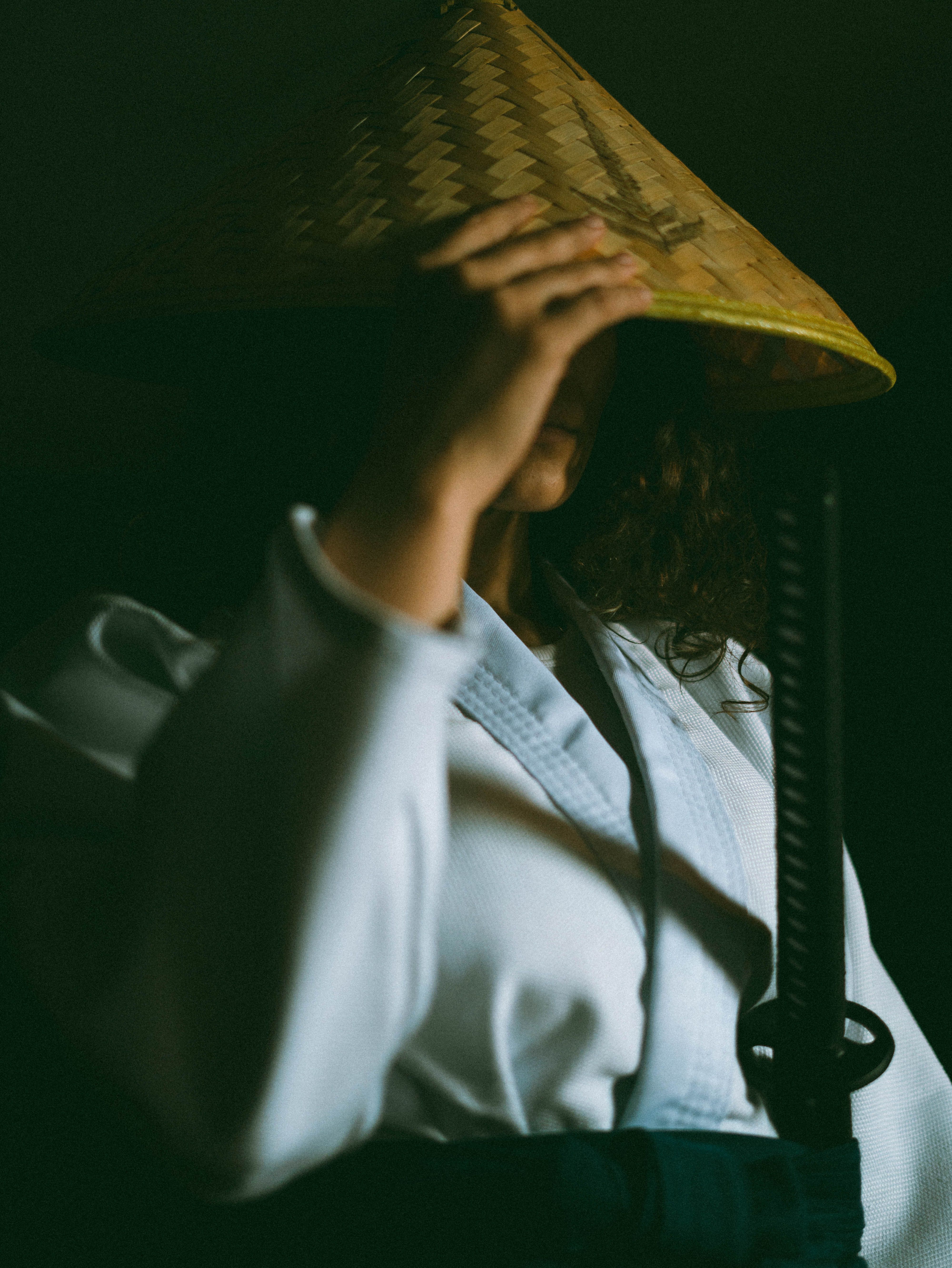 A samurai dressed in traditional attire holding a katana. Features a straw hat adding a mystic aura.
