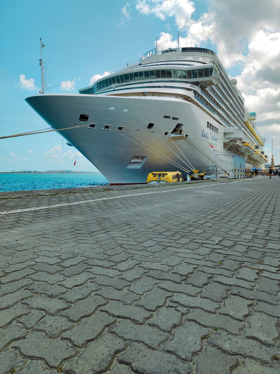 Cruise ship docked in a sunny harbor