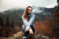 Woman in Cozy Sweater in Misty Autumn Mountain Landscape