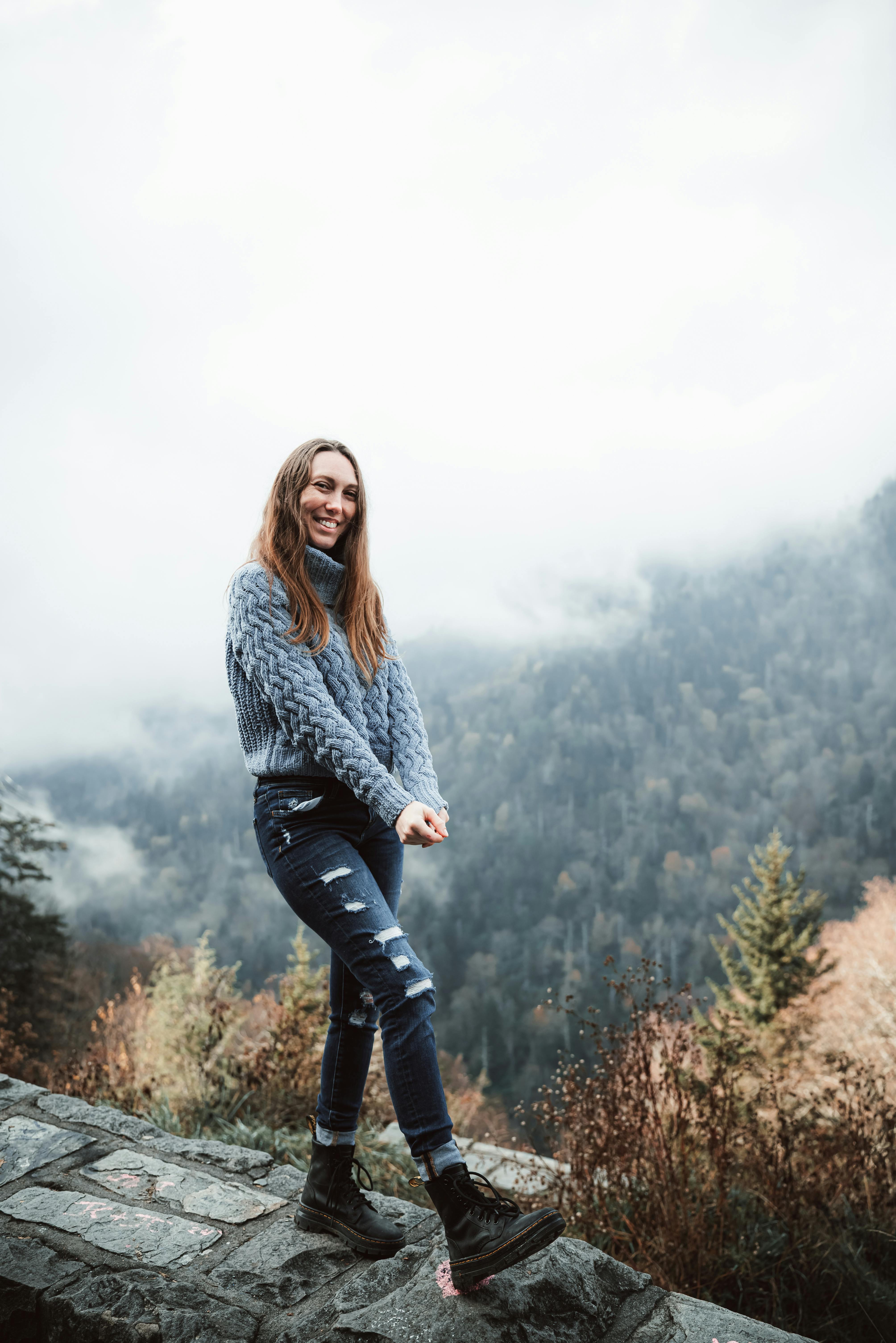 young woman standing in scenic fall mountain landscape