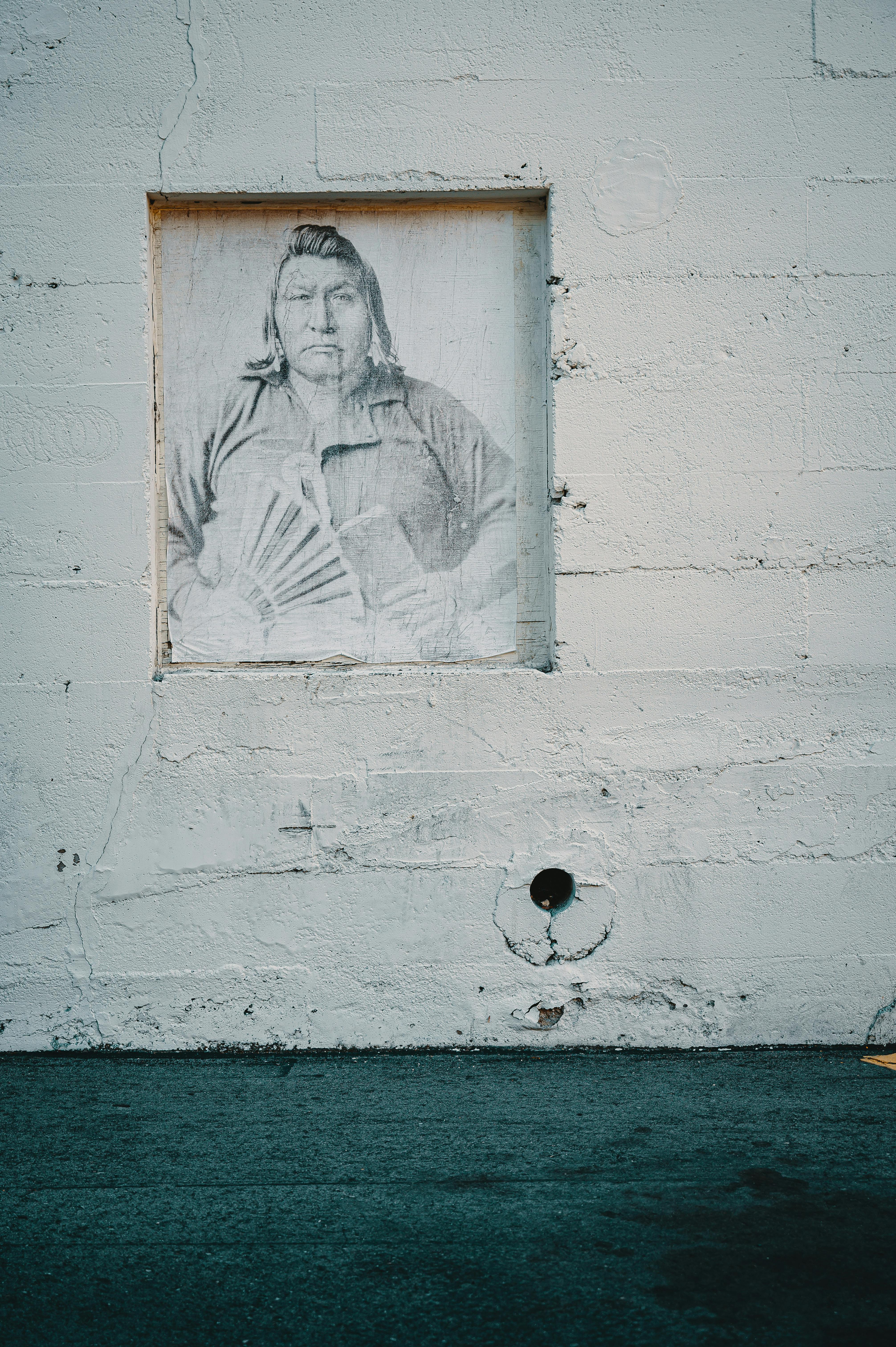 Street art depicting a historical figure on a concrete wall.