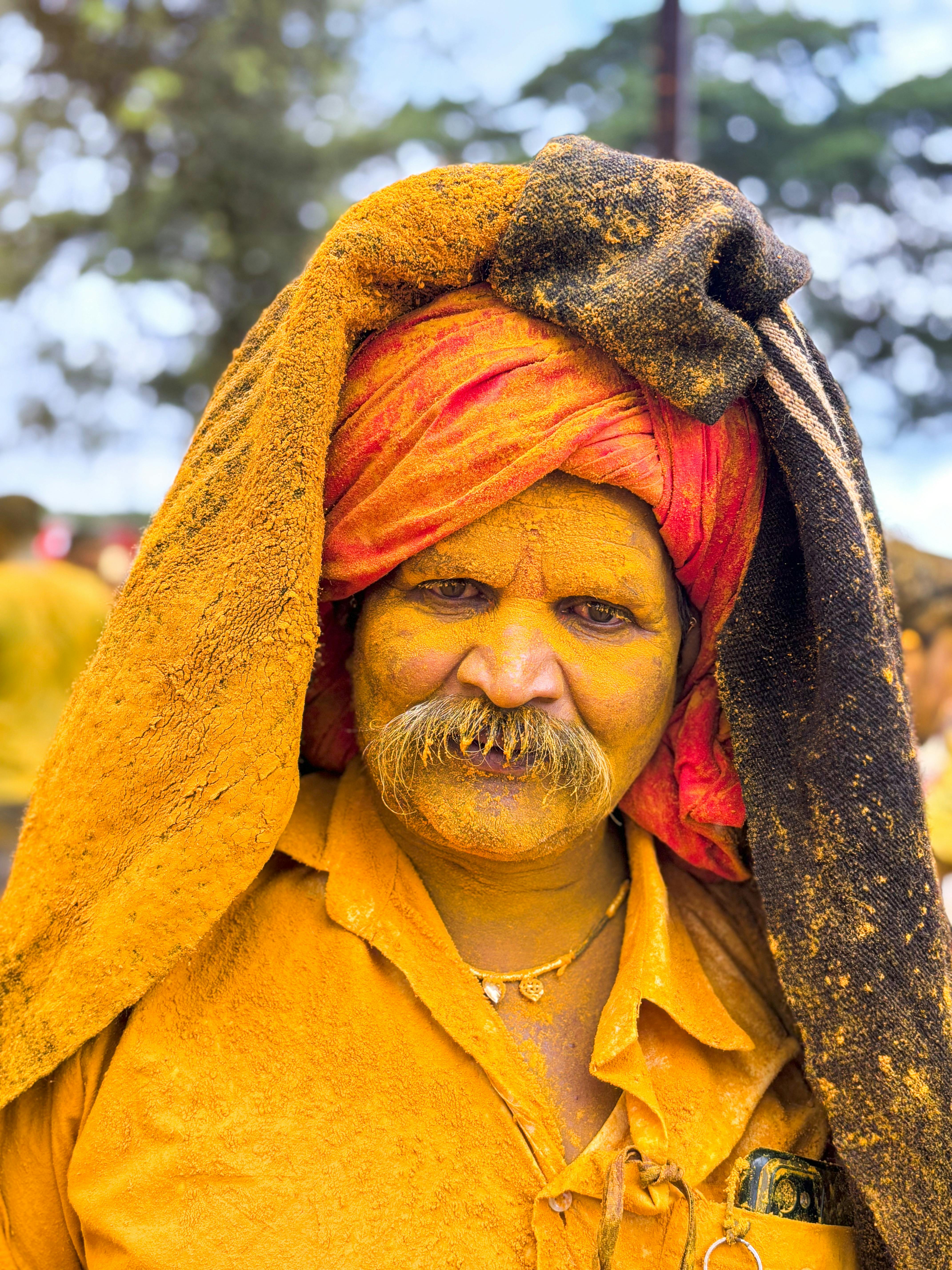 Colorful portrait of a man at Pattan Kodoli festival in Maharashtra, India.
