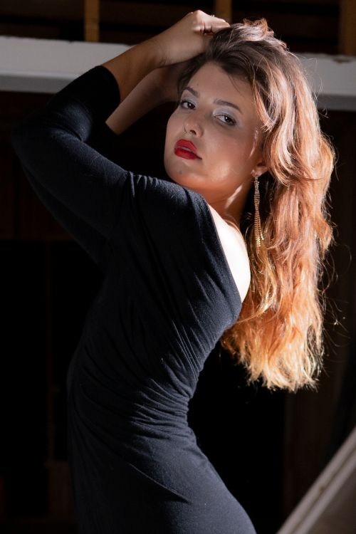 Elegant Woman in Black Dress Posing Indoors · Free Stock Photo