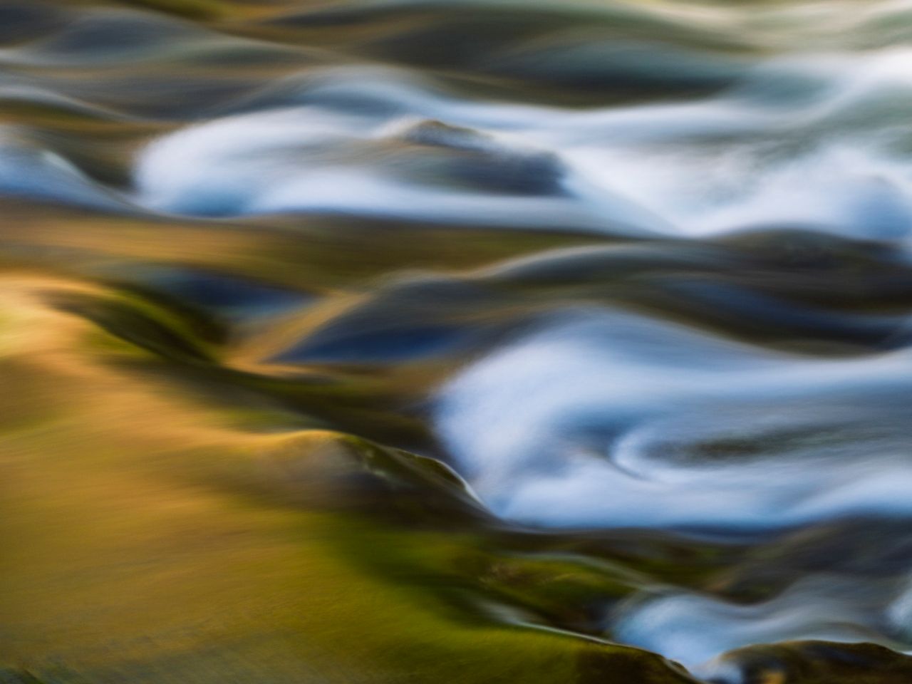 serene long exposure of flowing water in a natural landscape captures