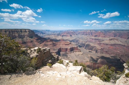 Free A breathtaking view of the Grand Canyon's vast landscape under a sunny sky. Stock Photo