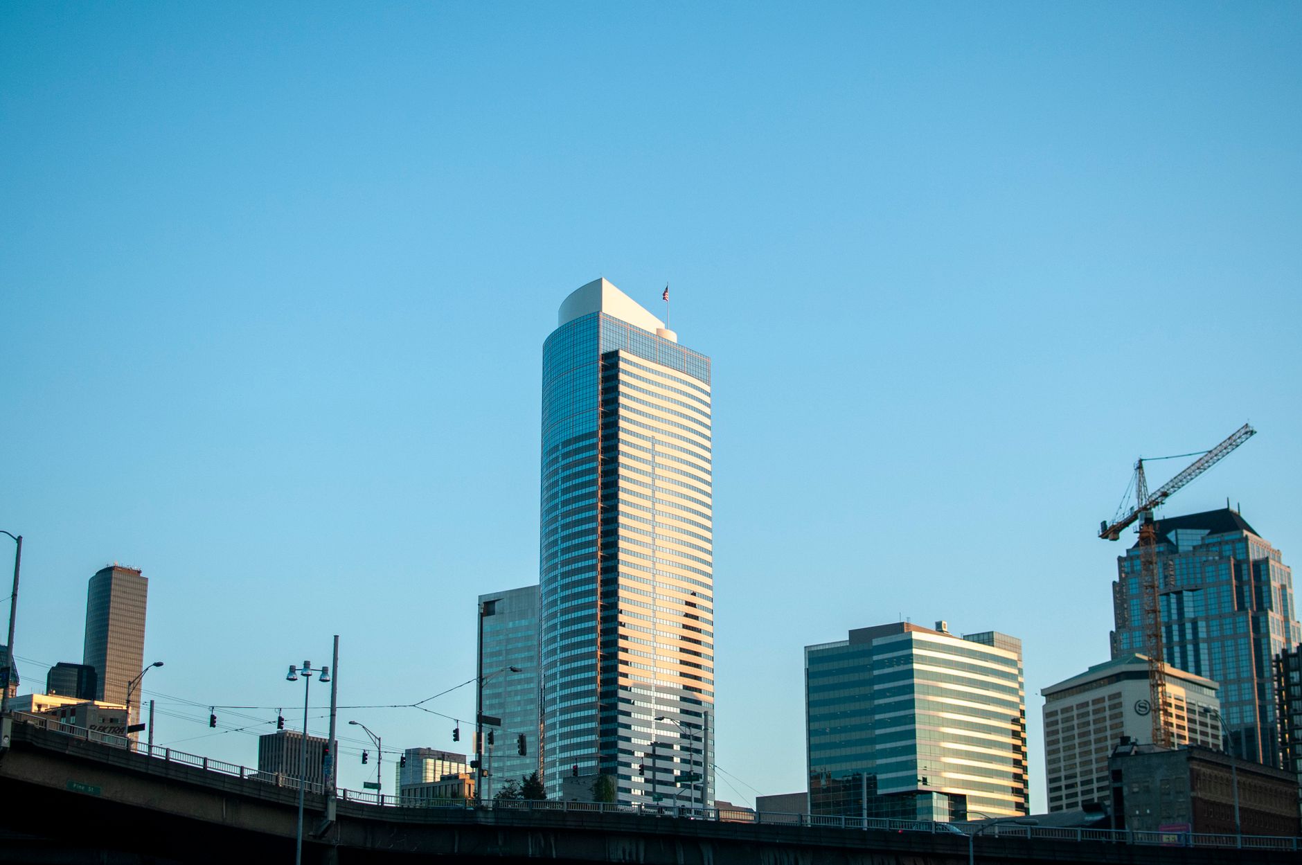 Urban skyline featuring towering skyscrapers against a clear blue sky.