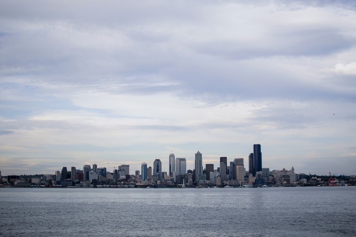 Seattle skyline seen across the water under an overcast sky, typical weather for anyone moving to Seattle or Bellevue