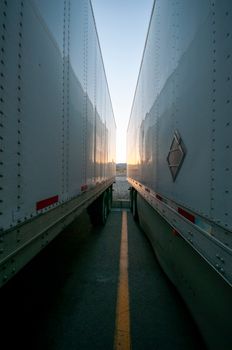 Captivating view between two trucks with sunset reflection creating a serene landscape.