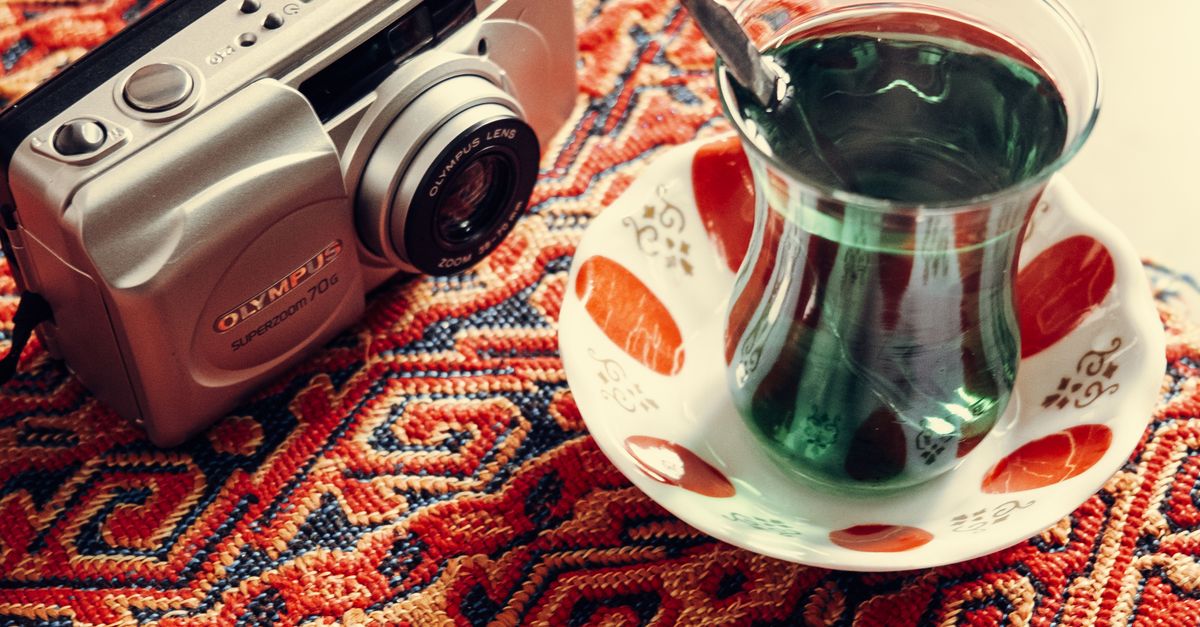 Vintage Camera and Tea on Patterned Rug · Free Stock Photo
