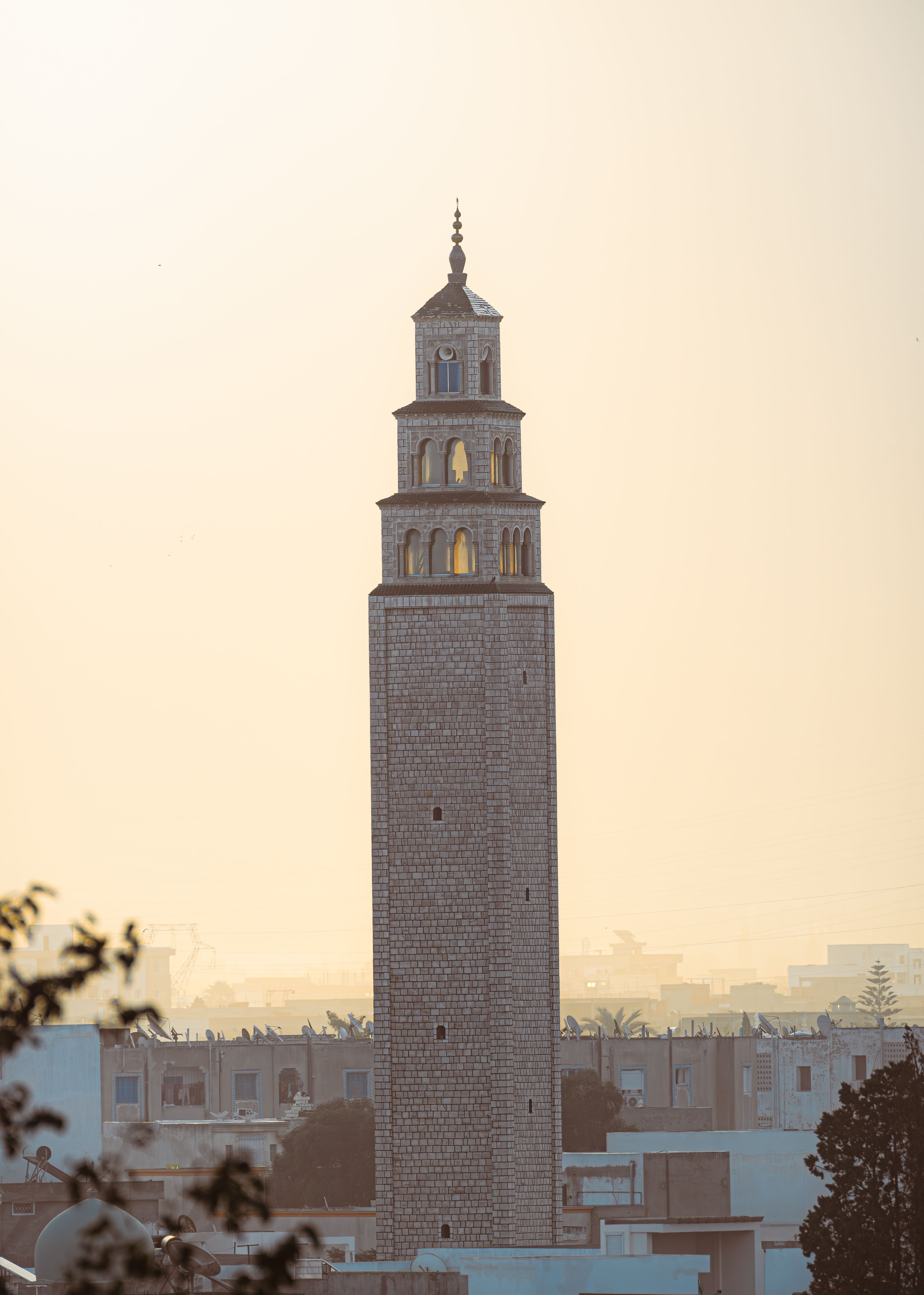 A stunning view of a historic minaret in Tunis, Tunisia, captured during golden hour.