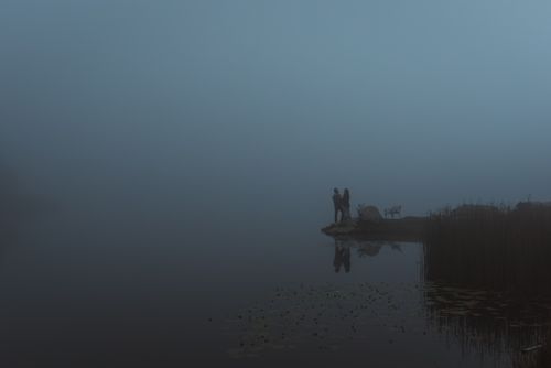 Free Silhouetted figures on a foggy lakeside in Styria, Austria, exuding tranquility. Stock Photo