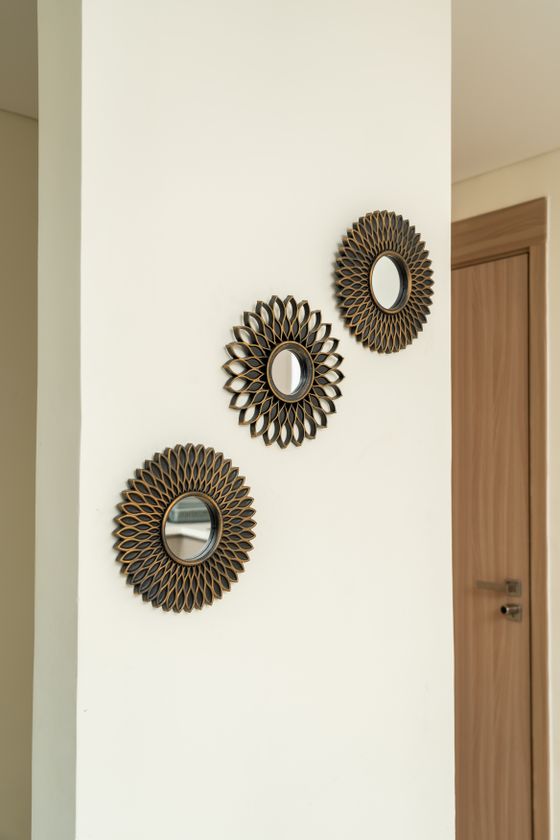 Three small sunburst mirrors grouped on a wall — photo by AJ Ahamad on Pexels