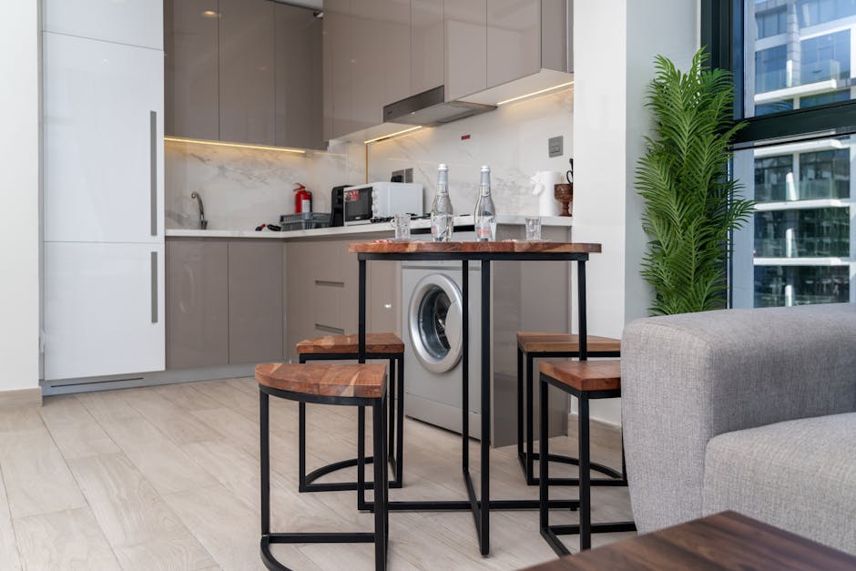 5 Essentials for Tiny Home Living: A Guide to Choosing the Perfect Foldable Table for a Calm and Minimalist Space Minimalist tiny home interior with a foldable table in a compact kitchen