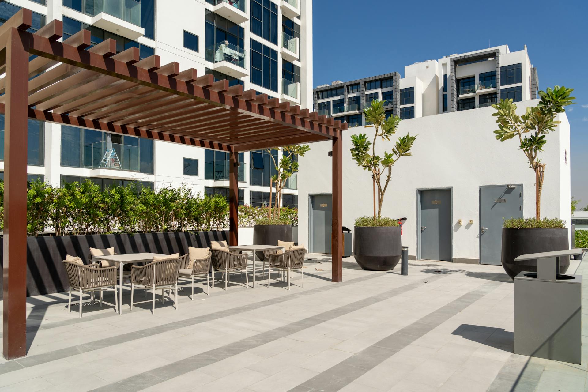 Sleek outdoor terrace with seating and pergola in Dubai's architectural setting.