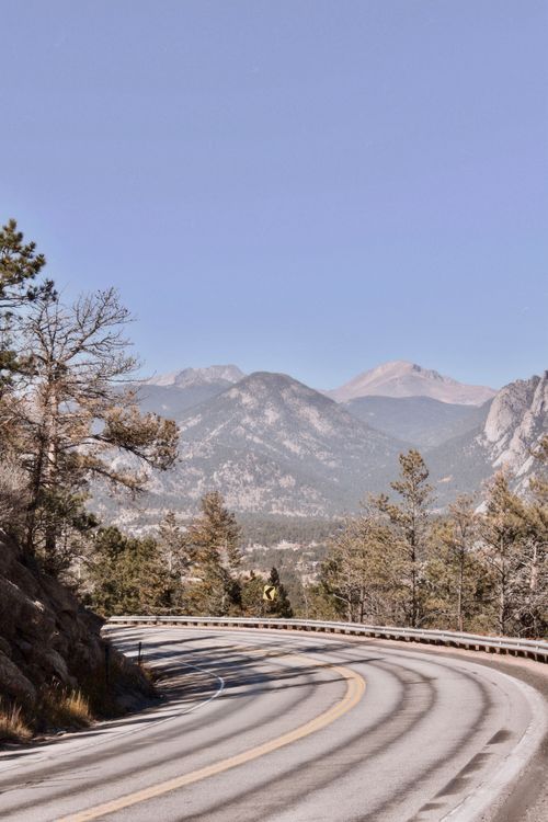 Free Captivating winding road with mountain backdrop in Rocky Mountains. Stock Photo
