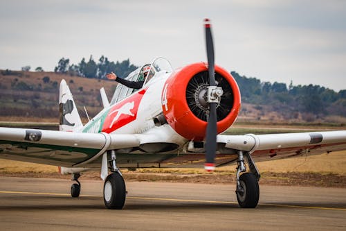 White and Orange Airplane on Runway