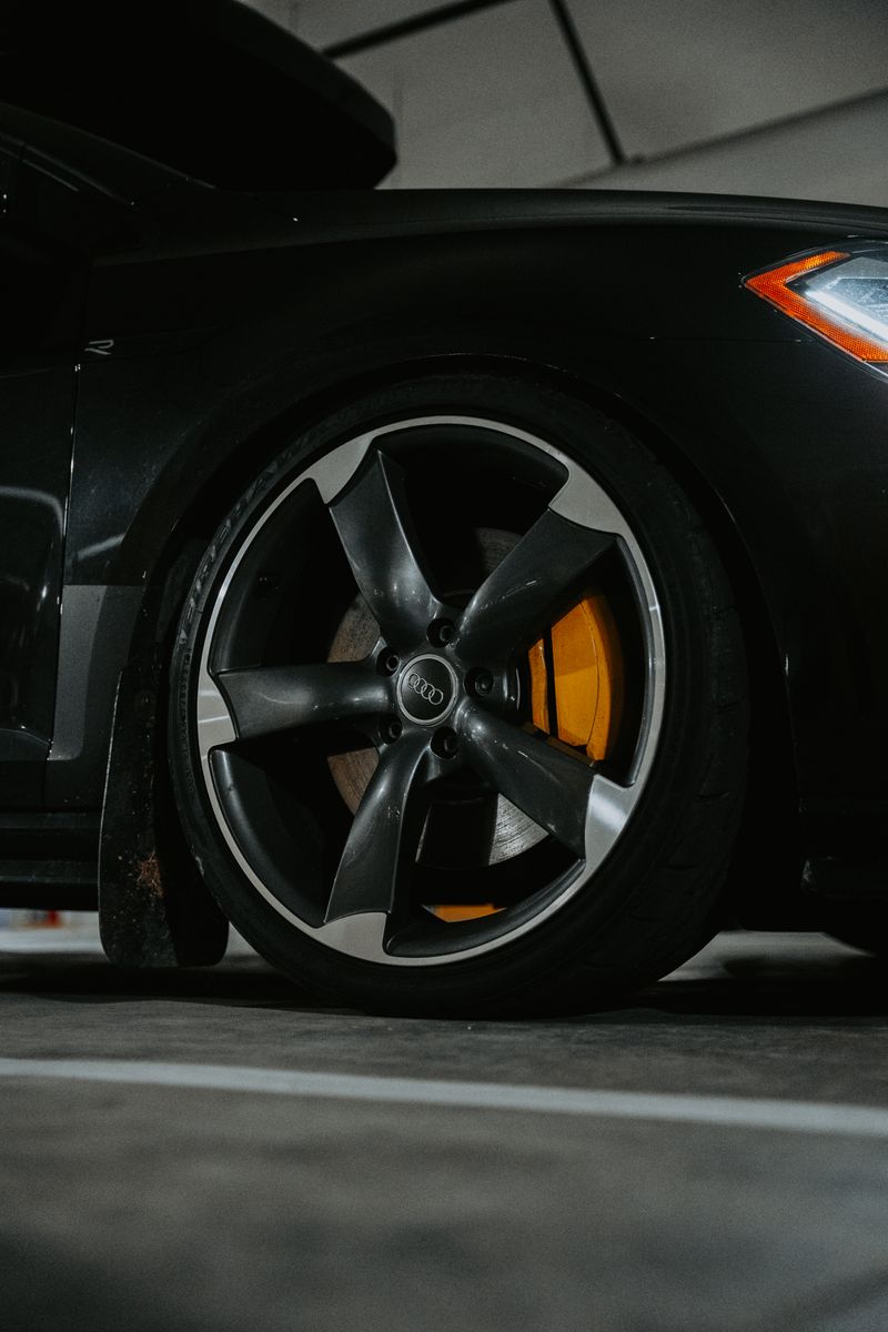 Brake caliper and wheel detail on track-prepared vehicle showing suspension clearances