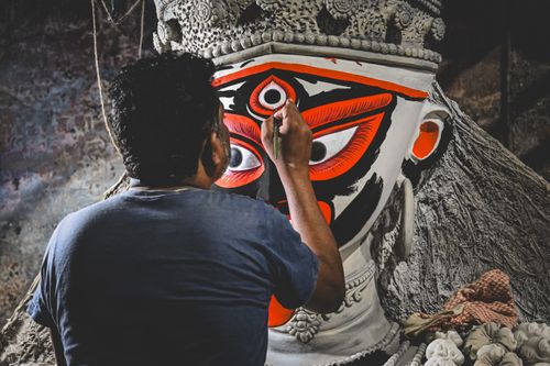Free An artist skillfully paints a traditional Goddess Kali idol in Kolkata, India. Stock Photo