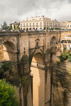 Dramatic view of Puente Nuevo, the iconic bridge in Ronda, Spain, spanning a deep gorge.