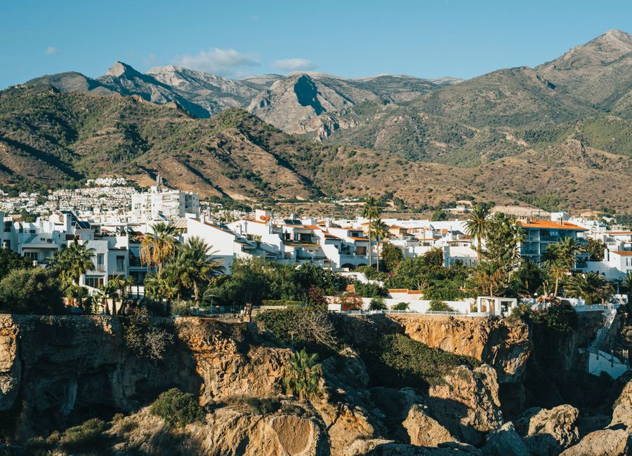 Scenic view of Nerja, Andalusia with white buildings and mountains. Perfect for travel and architecture themes.