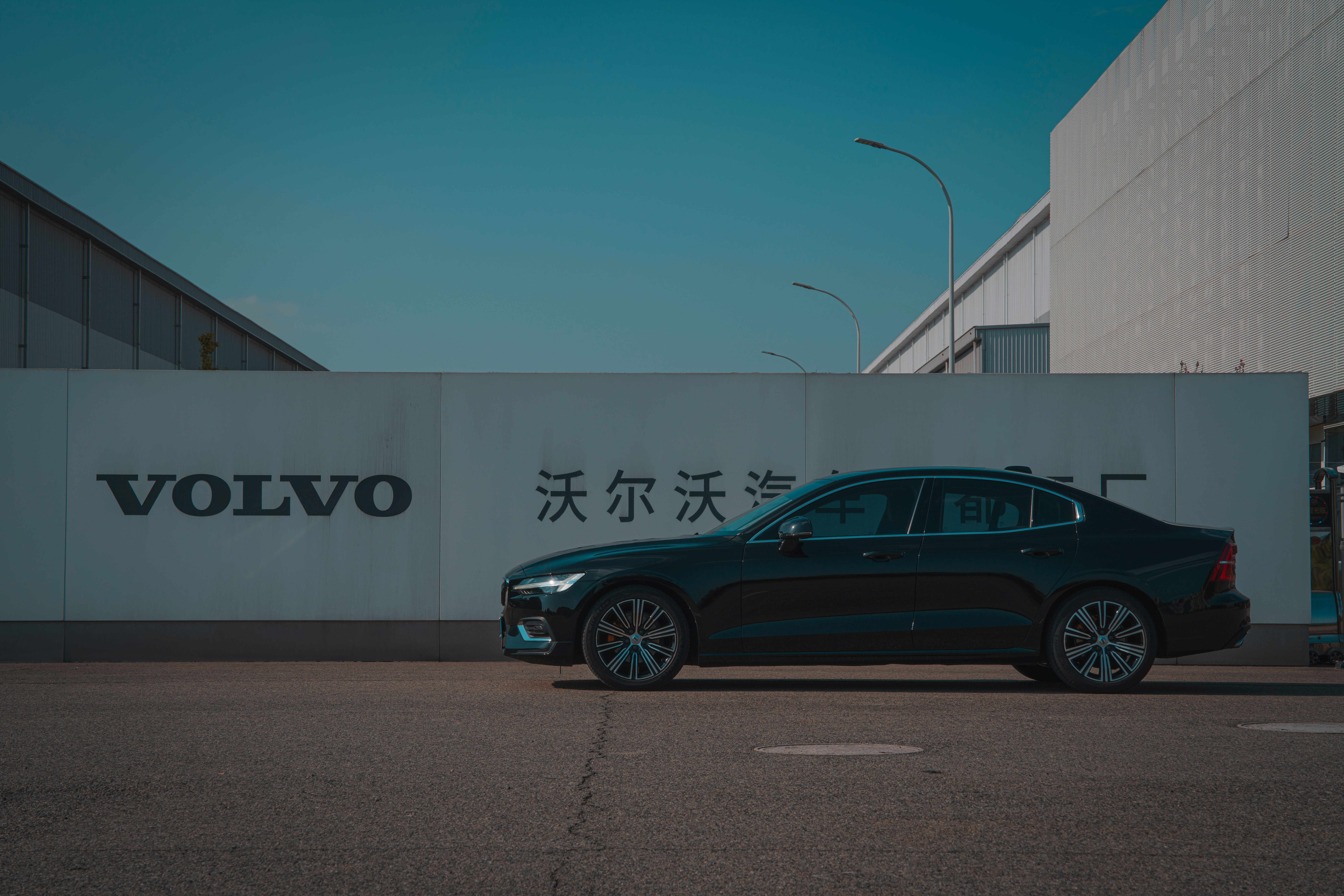 Black Volvo Sedan at Manufacturing Facility · Free Stock Photo