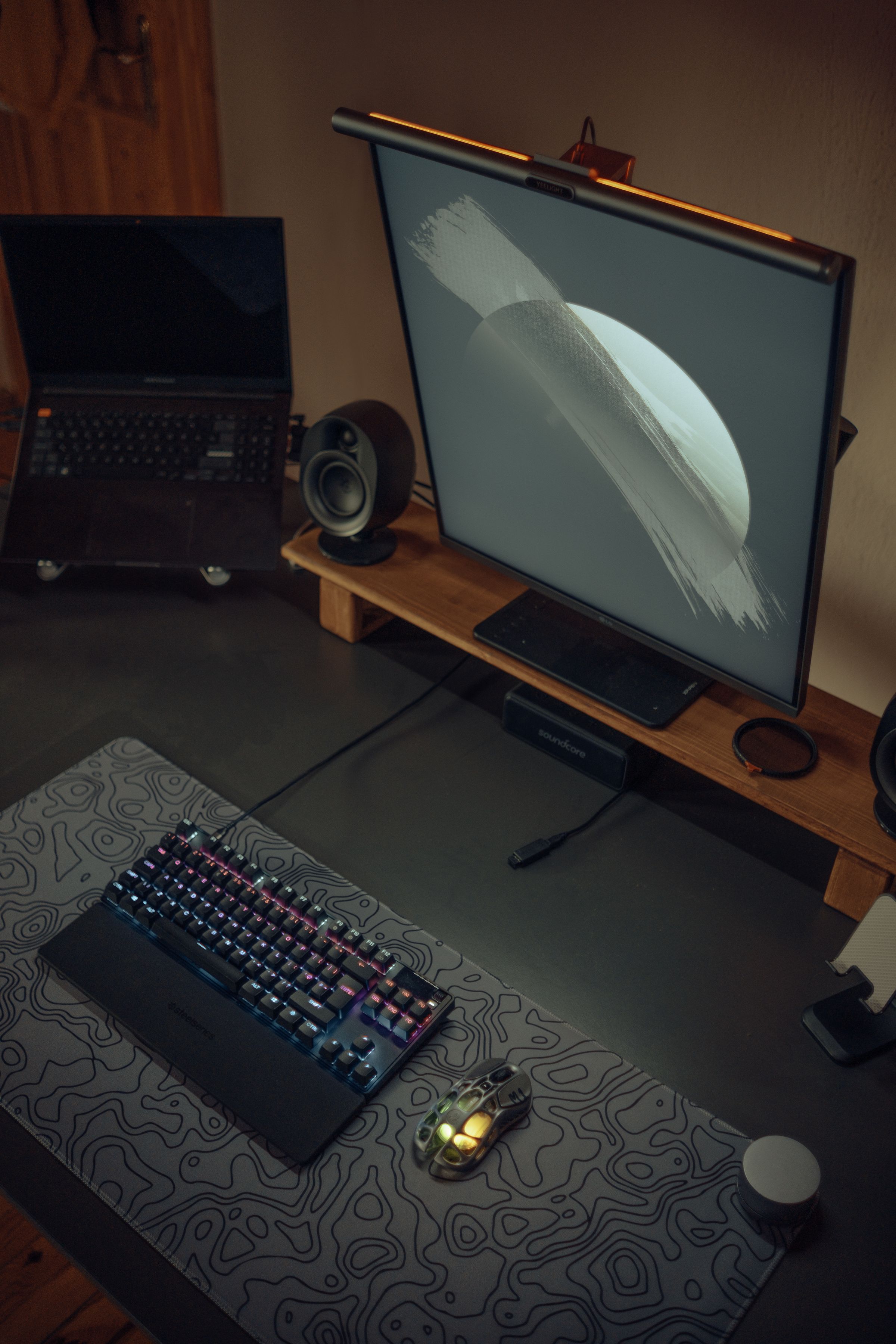 Modern desk setup with monitor keyboard mouse and RGB lighting