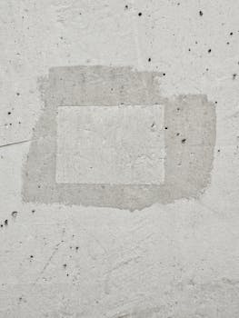 A close-up of a textured concrete wall showcasing a rough patchwork design.
