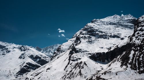Free Majestic snow-covered mountains under a clear blue sky in Sissu, Himachal Pradesh, India. Stock Photo