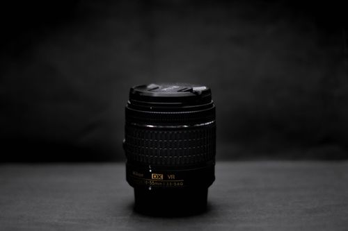 Free Detailed close-up of a Nikon lens, showcasing optical technology on a dark studio backdrop. Stock Photo
